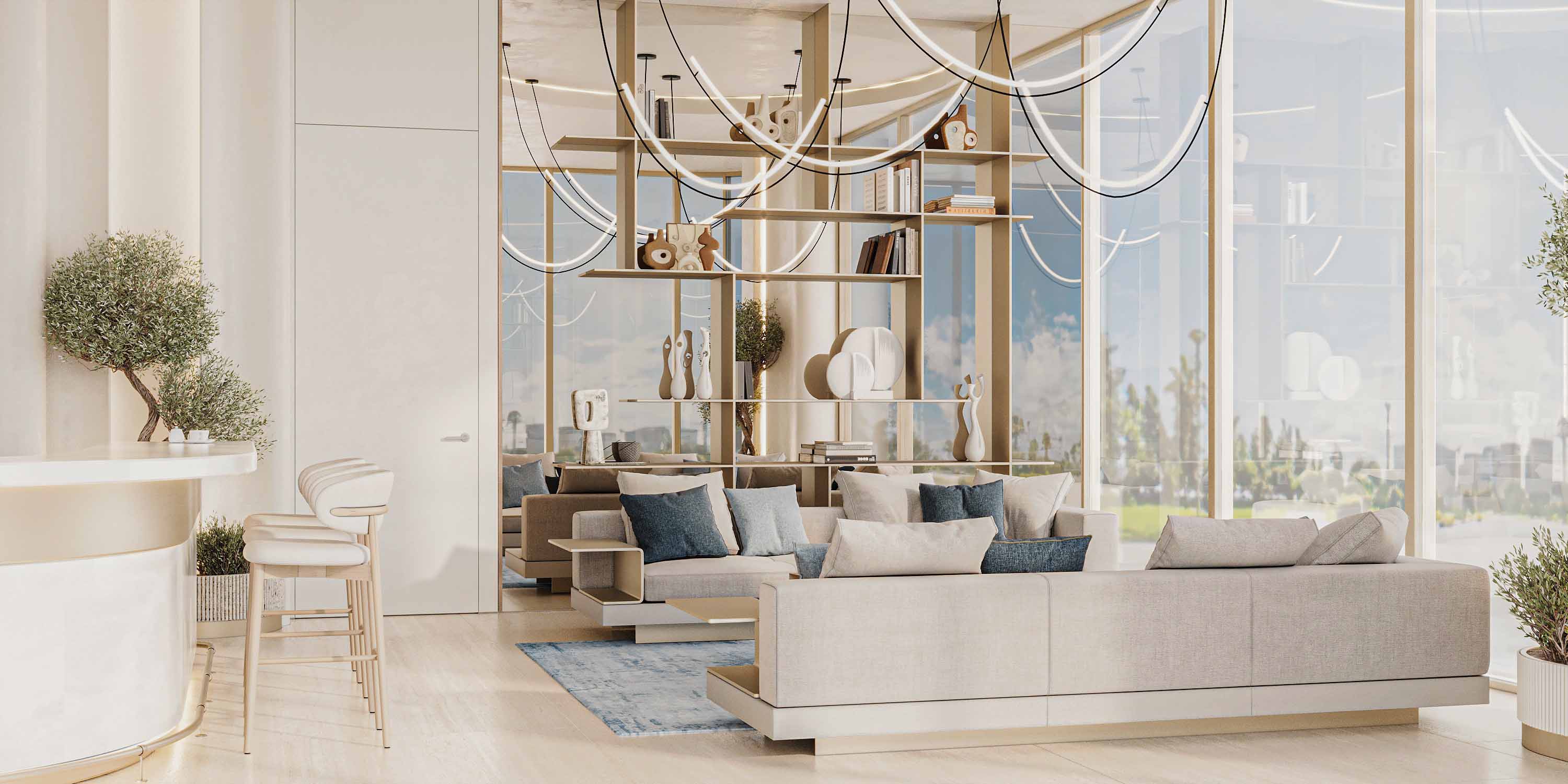 Cove Edition Iii By Imtiaz A modern living room featuring light-colored furniture, decorative plants, and a stylish shelving unit.